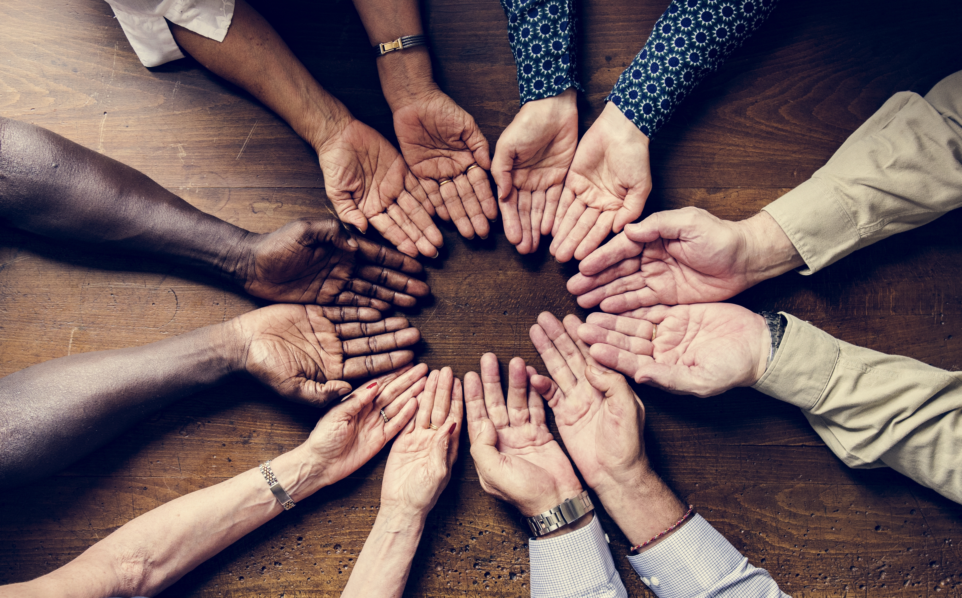 spiritual group of people showing their diverse hands