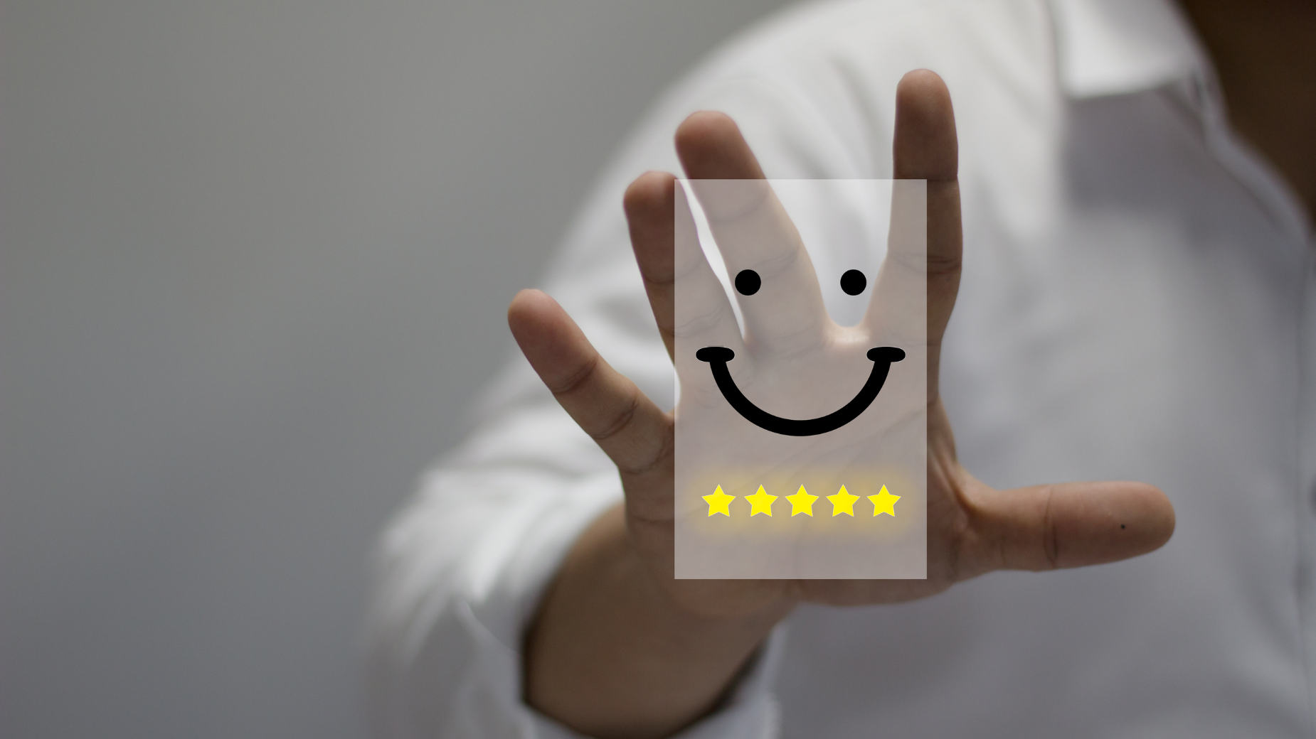 Businessman holding card with smiley, concept of customer satisfaction