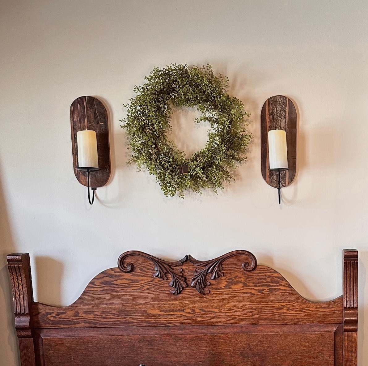 candle sconce above headboard