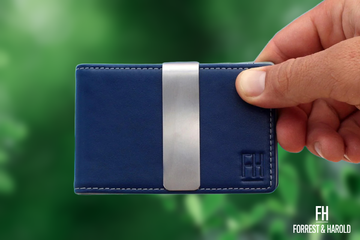 Blue Forrest and Harold wallet with greenery in the background...
